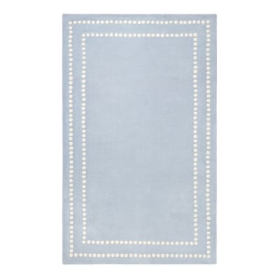 An alternative to the Pottery Barn Kids rug, adorned with white dots.