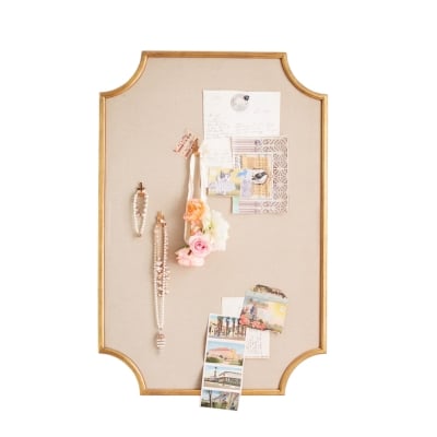 A bulletin board with a variety of items on it.