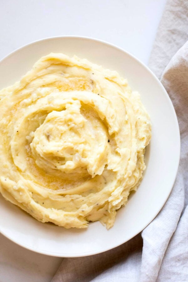 caramelized onion mashed potatoes in a white bowl