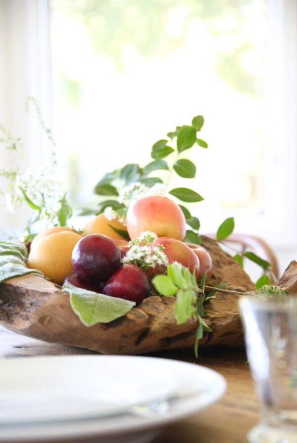 a diy fall centerpiece in a rustic wood bowl