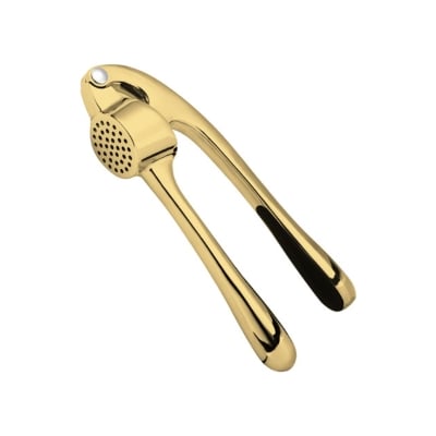 Gold-colored garlic press kitchen gadget on a white background.