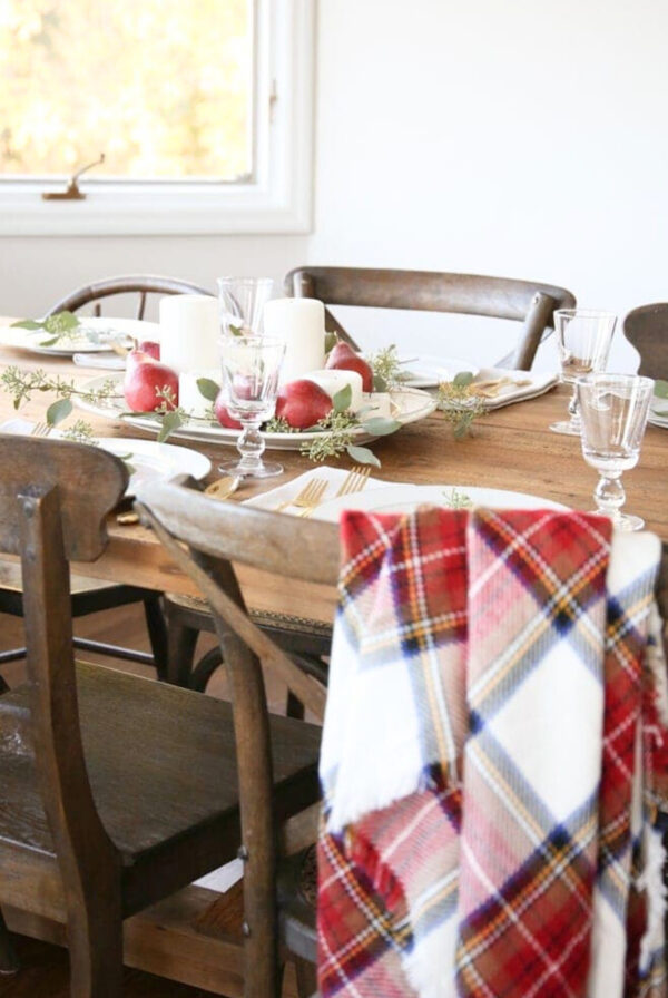 A last minute Thanksgiving centerpiece of candles, fruit and greenery.