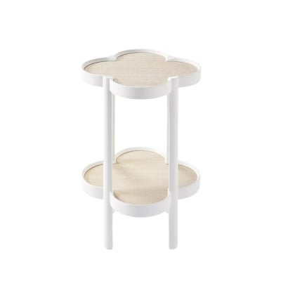 A white side table with scalloped decor and a flower on top.