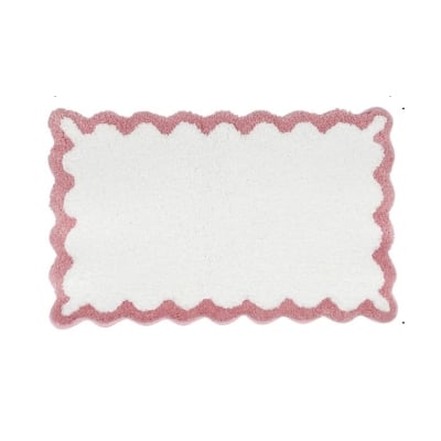 A pink and white scalloped decor rug on a white background.