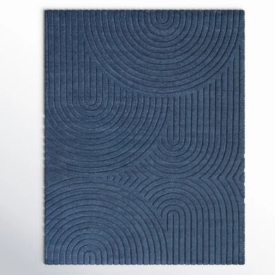 A blue textured rug with an embossed pattern of intersecting concentric circles and lines, perfect for any space. Consult our rug size guide to find the ideal fit for your room.