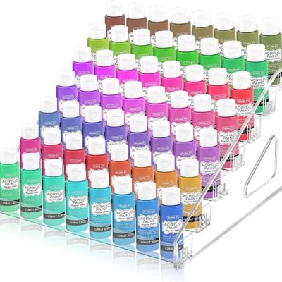 Acrylic paint bottles neatly arranged in a clear, tiered plastic rack make organizing crafts effortless and stylish.