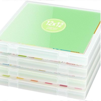 A stack of four transparent plastic boxes ideal for organizing crafts, each housing 12x12 paper. The top box proudly displays a green label, perfect for easy sorting during creative projects.