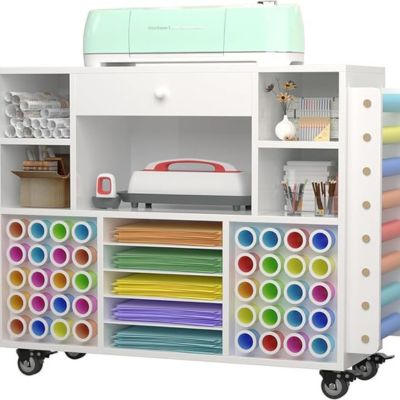 Organize your craft space with a versatile storage cart, featuring a mint-colored cutting machine on top. Colorful rolls of vinyl, paper sheets, and craft tools are neatly arranged in compartments. Its wheels ensure easy mobility, making it a perfect addition to any creative corner.