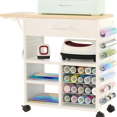 A white crafting cart enhances your craft space ideas, featuring a printer on top, a small drawer, open shelves for rolls of vinyl and supplies, plus a side rack to organize all materials effortlessly.