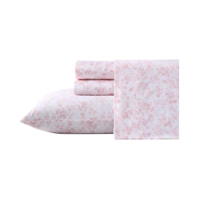 The Pink floral bed sheet set, featuring a pillowcase, fitted sheet, and flat sheet, offers a LoveShackFancy look for less. Each piece is artfully folded and displayed against a pristine white background.